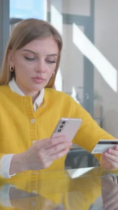 Woman Shopping Online With Phone and Credit Card