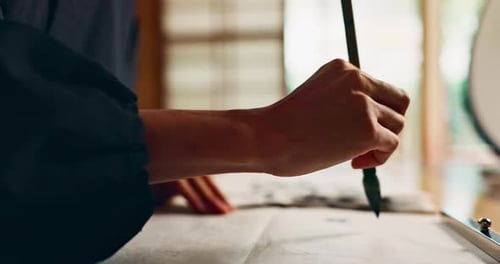 Calligraphy Artist Drawing Characters on Paper