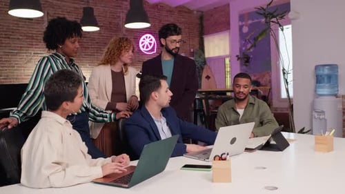 Coworkers Collaborating on Project in Modern Office Slow Motion