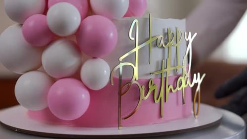 Pink and White Birthday Cake with Decorations