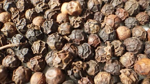 Wrinkled Black Peppercorns in a Close Up Shot