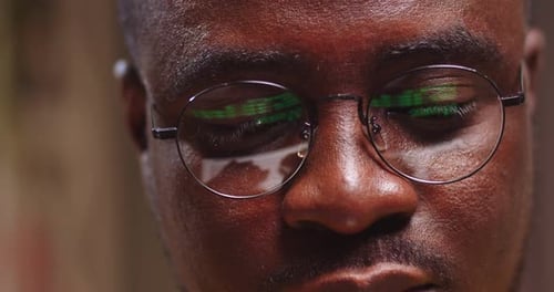 Close Up of Programmer Man Face in Glasses with Laptop Screen Reflection Goodlooking Guy Working on