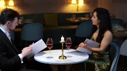 Smiling Man and Woman Making Order in the Restaurant While Having Romantic Date Lifestyle Love