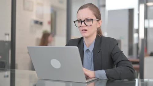 Frustrated Woman Experiencing Headache While Using Laptop