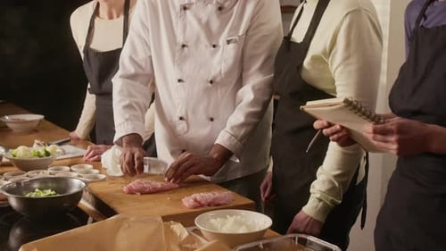 Chef Teaching Group of Women How to Cut Chicken During Cooking Master Class