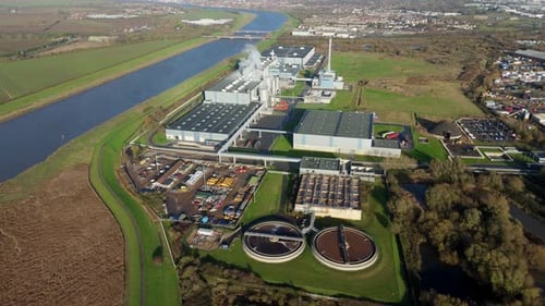 High Altitude Aerial View Of Massive Paper Manufacturing Factory With Industrial Cooling Ponds In