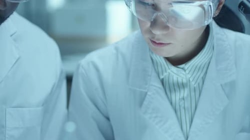 Scientists Studying Plant Life in Laboratory Setting