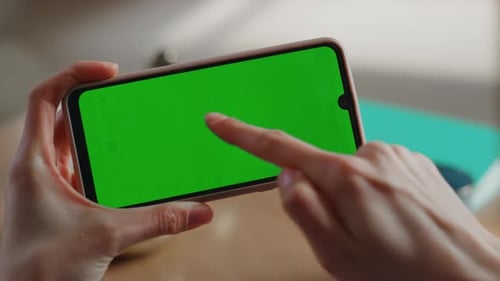 Smartphone Green Screen Tap in Bright Workplace