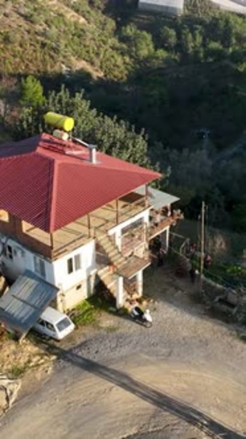 Vertical Video Aerial Beauty Unveiling Mountain Farming Homes and the Enchanting Greenery