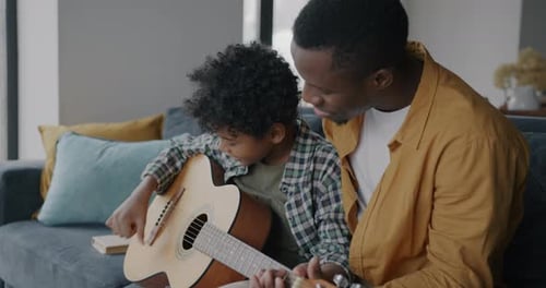 Father and Child Play Acoustic Guitar Together