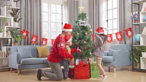 Family Decorating Christmas Tree in Festive Home