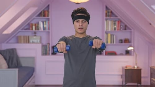 Indian man lifting dumbells and doing exercise