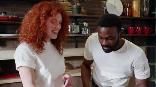 Couple Cooking Together in a Bright, Cozy Kitchen