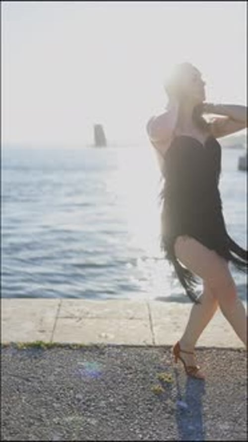 Woman Dancing on Pier by the Ocean