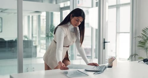 Woman Reviews Documents at Modern Office Desk