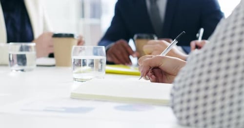 Hand, writing and a business person in a meeting for planning with her team in the boardroom