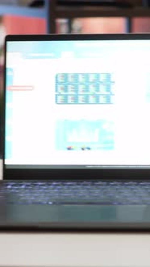 Vertical Video Empty Home Office with a Laptop Showing Financial Data Sales Reports