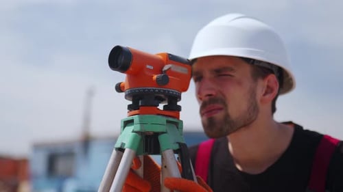 Close Up Shot of Professional Construction Worker Using Theodolite Surveying Optical Instrument Man
