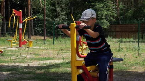 Child Boy Engaged on Sports Training Simulator at the Street