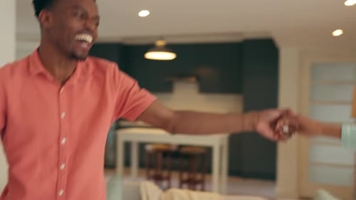 Happy Couple Dancing Joyfully Together at Home