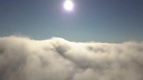 Aerial View From Above of White Puffy Clouds in Bright Sunny Day