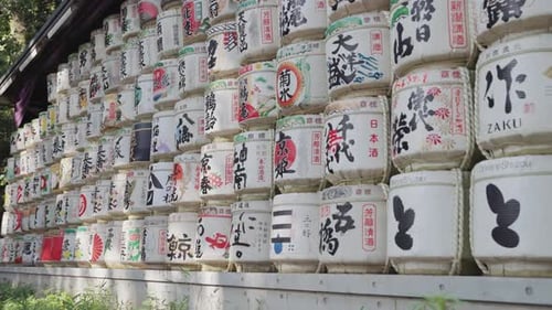 Slow-motion video of beautifully decorated sake barrels at Meiji Jingu Shrine during the daytime in