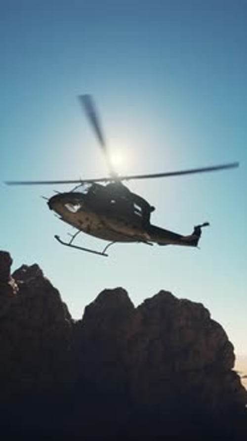 Military Helicopter Flying Over Mountain Range