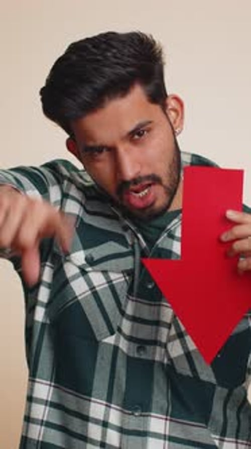 Upset Indian Man Showing Red Arrow Pointing Down Concept of Downgrade Bankruptcy Money Fail Fall