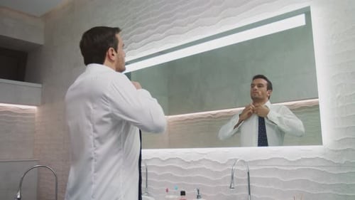 Business Man Buttoning Shirt at Luxury Bathroom. Happy Man Dressing Himself In
