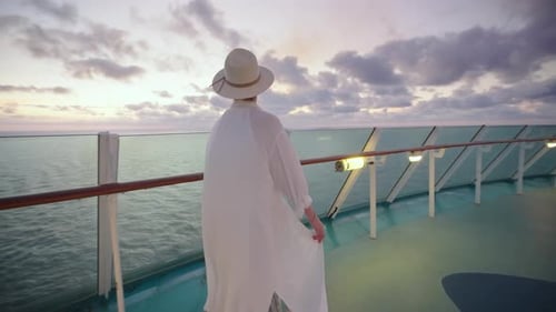 Woman Walking on Cruise Ship Deck at Sunset