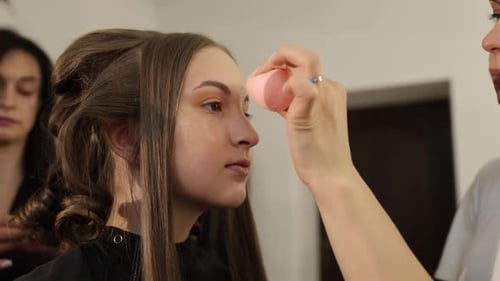 Teen Girl Getting Makeup Applied by Makeup Artist