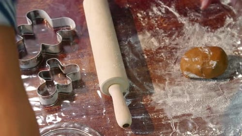 Woman Rolling Out Cookie Dough for Christmas Baking
