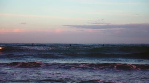 Ocean waves and surfers at the sea in slow motion