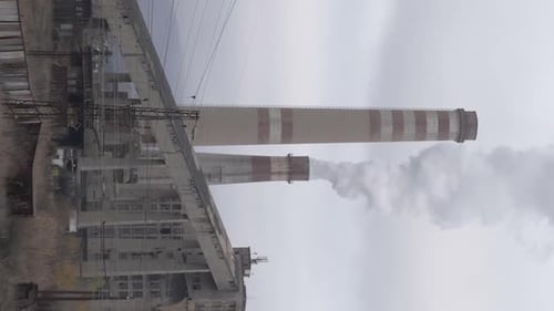 Vertical Video of Factory Chimney Smoking Dense Pollution Above Pernik City