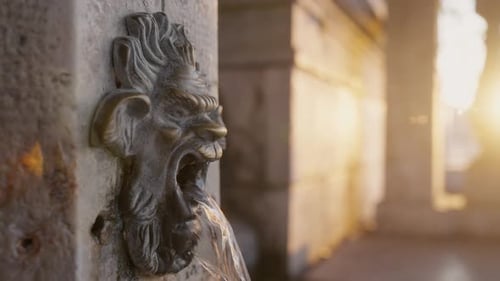 Venetian Wall Fountain with Grotesque Mascaron Water Spout at sunriseOld Venice