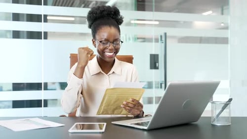 Woman Receives Good News at Office Desk