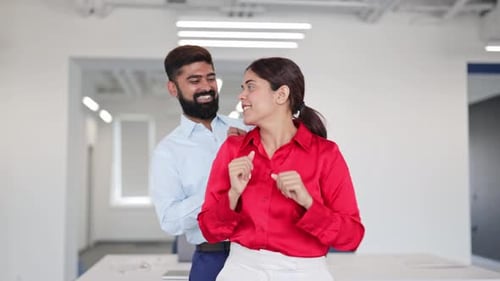 Joyful Indian Colleagues Dancing in Office