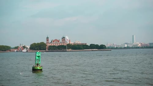 Sailing In Upper New York Bay With Distant View Of Immigration Museum At Ellis Island In New York Ha