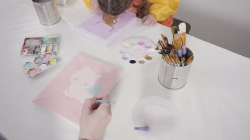 Little Girl Painting with Acrylic Paint on Canvas with Her Mother for a Distant Learning Art Project