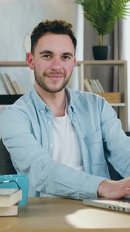 Close Up of Likable Man Which Posing on Camera at the Table in Beautifully Decorated Room for Remote
