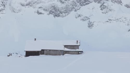 Idyllic Winter Mountain Retreat with a winter cabin.