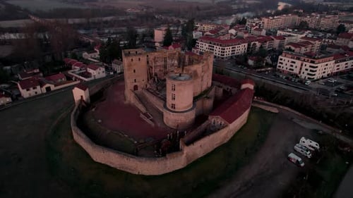 drone shot moving away from Montrond les bains Castle revealing the Plaine du Forez at sunrise, Loir