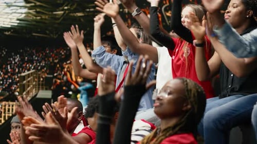 Diverse Sports Crowd Cheering and Making Chants During Football Match