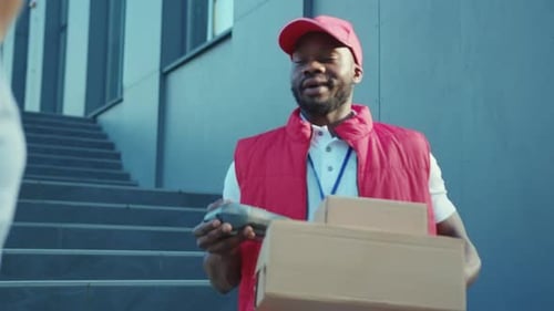 Close Up African American Delivery Man Hold Package Woman Client Paying By Phone for Parcel