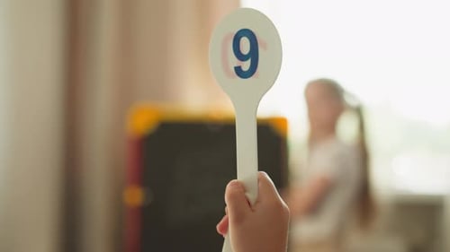 Girl Writing Math Problems on Chalkboard