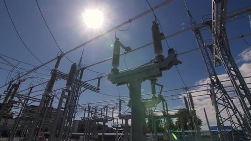 Pole with Insulators and Power Lines Against Blue Sky