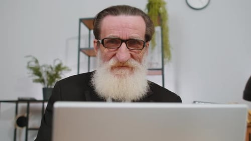 Closeup Businessman Freelancer at Office Workplace Working on Laptop Computer Sends Online Messages