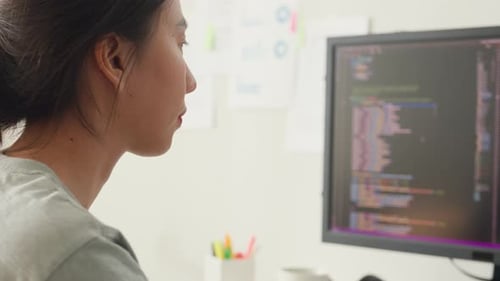 Close-up young Asia girl IT development programmer typing on keyboard coding programming.