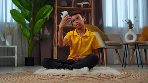 Teen Using Smartphone Indoors at Home
