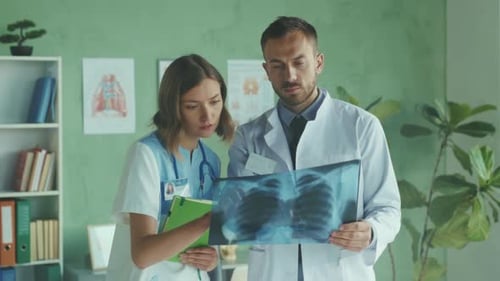 Doctors Reviewing Chest X-Ray in Medical Office